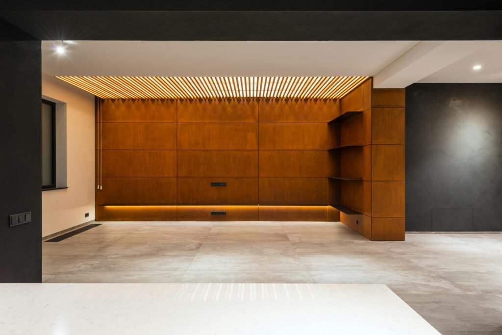 A contemporary, minimalist room with wooden accents and ambient lighting.