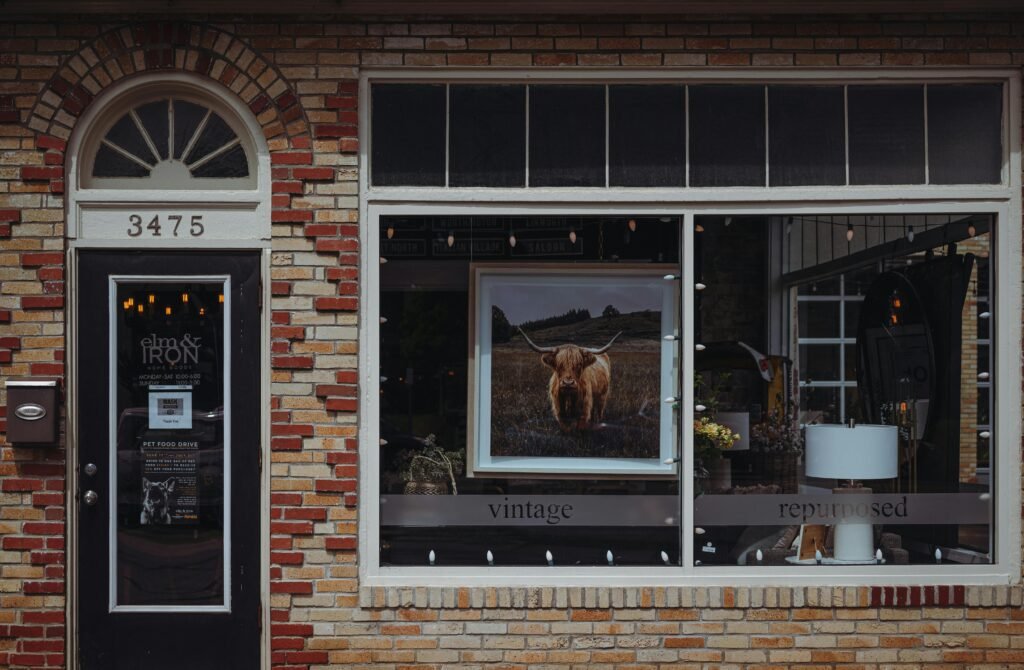 A picturesque vintage café storefront with a brick facade, featuring unique decor and signage.